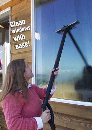 Woman cleaning windows steam cleaner